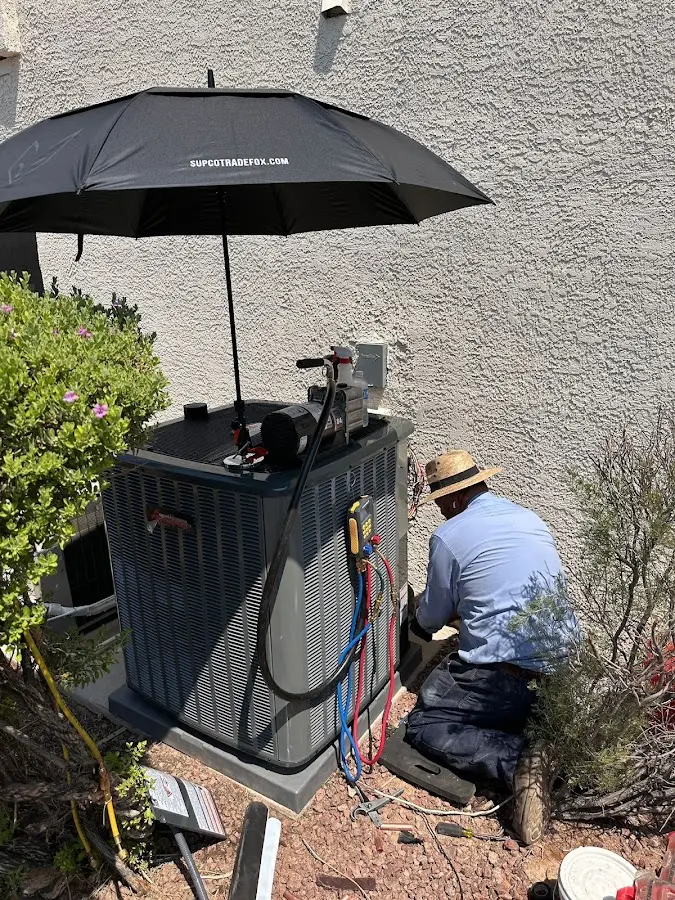 HVAC technician performing outdoor AC maintenance in Bolivar